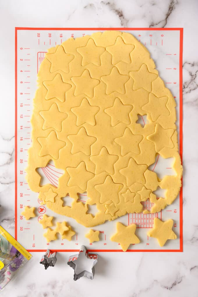 Cutting out stars from sugar cookie dough.