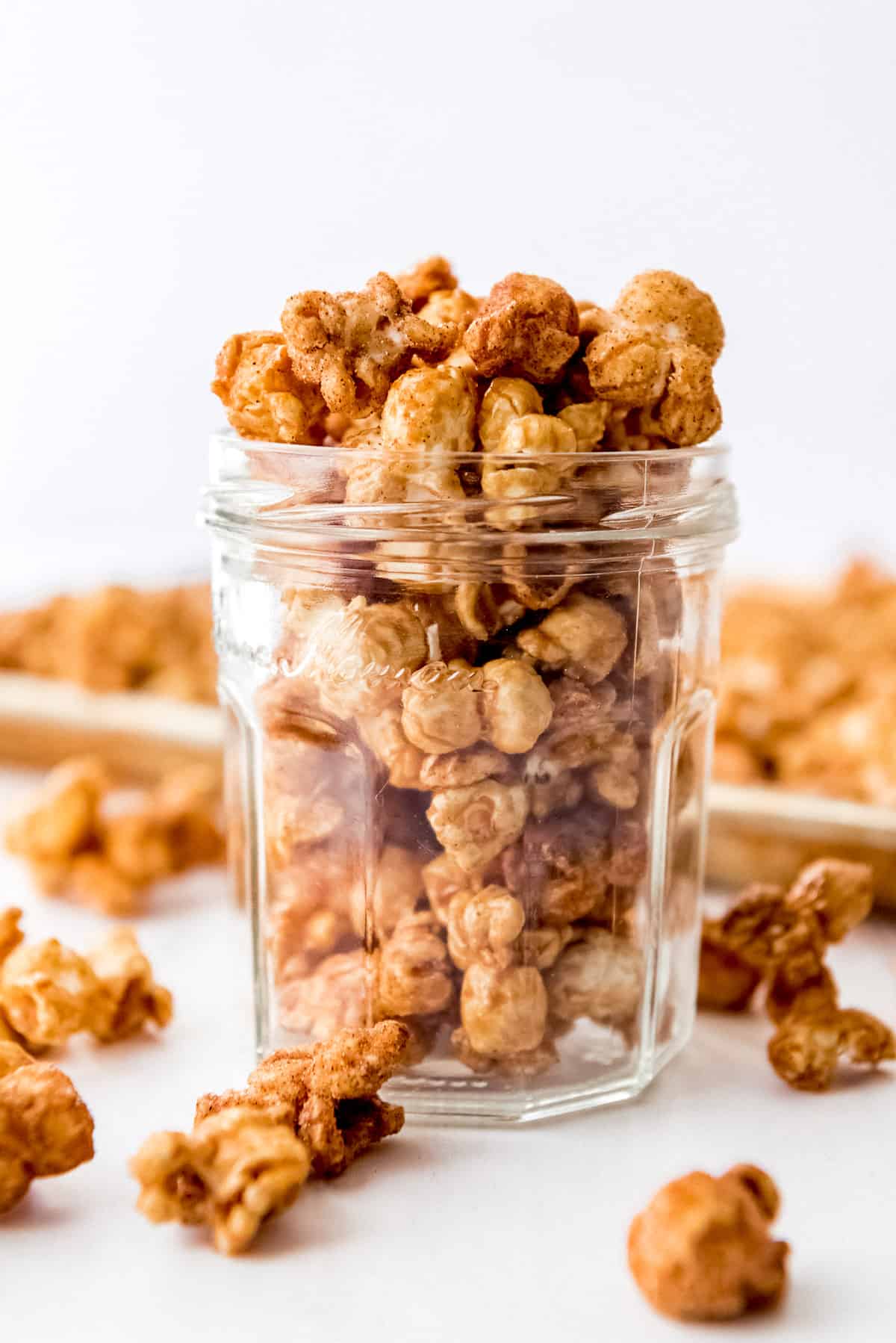 A jar filled with churro popcorn as a serving suggestion.