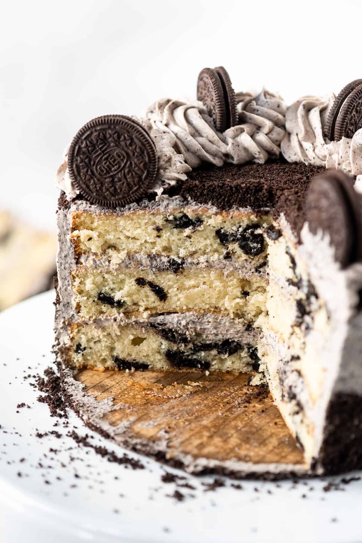 A cross-section image of layers of homemade white cake with Oreo pieces baked into them.