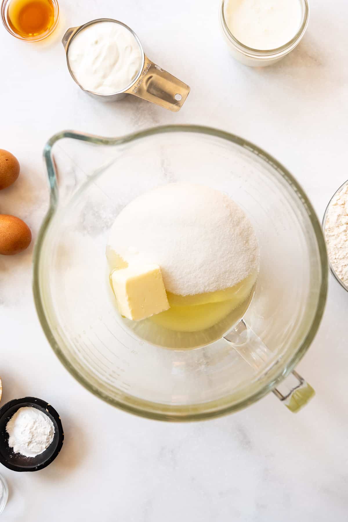 Oil, butter, and sugar in a large glass mixing bowl.