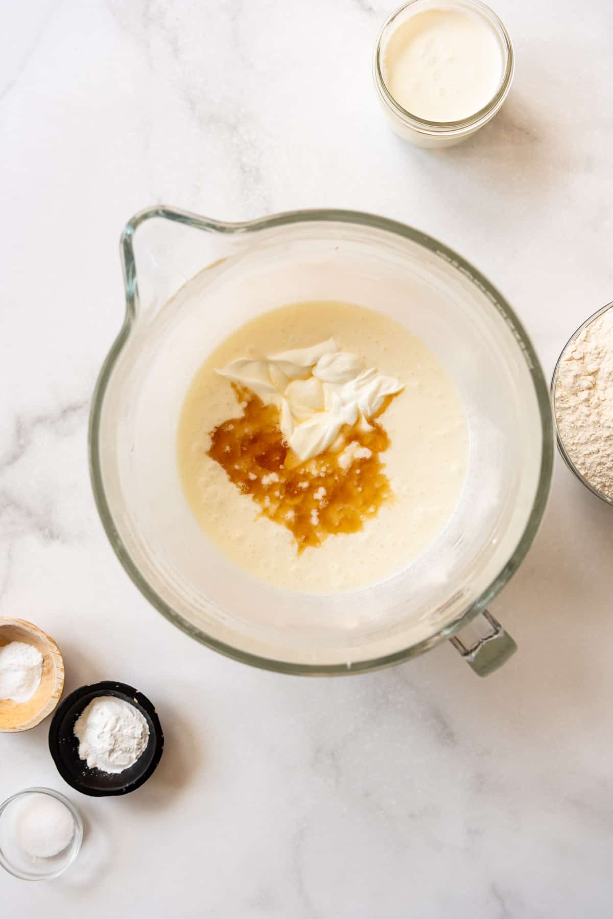 Adding sour cream and vanilla to white cake batter.