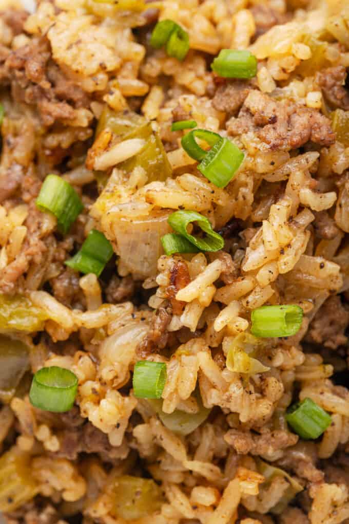 A close image showing the texture of dirty rice with onions, celery, green pepper, and ground beef.