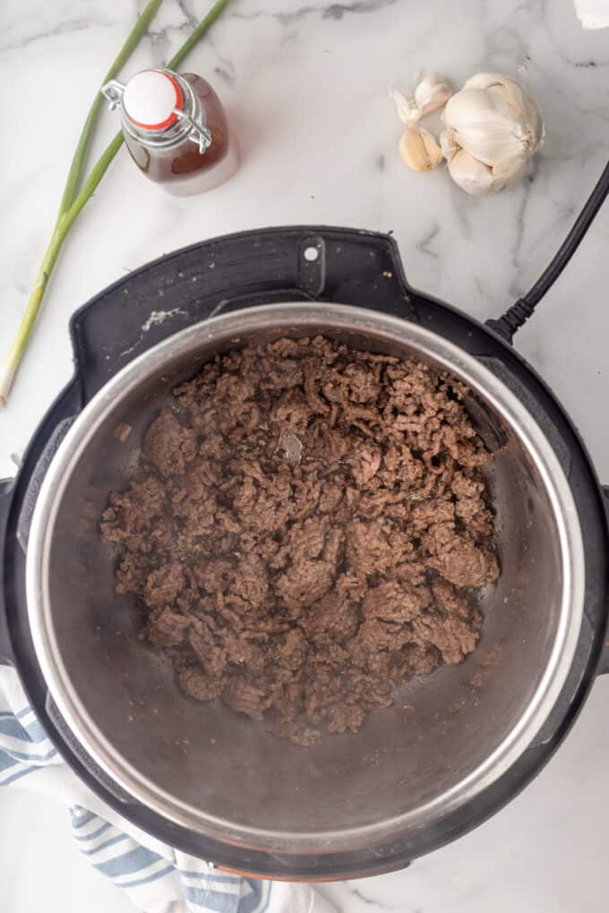 Browned ground beef in an instant pot.