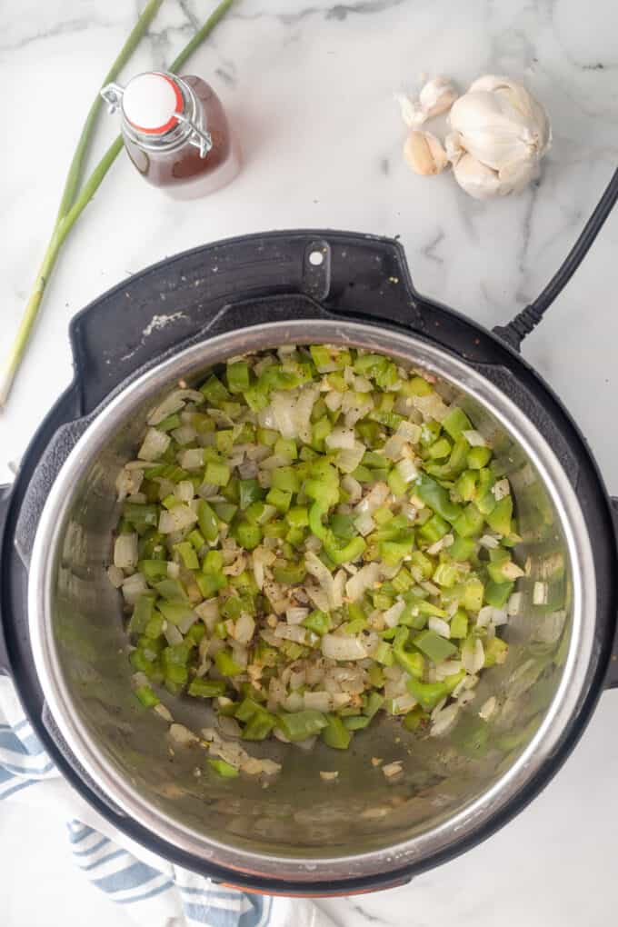 Sauteed onions, green bell pepper, and celery in an instant pot.