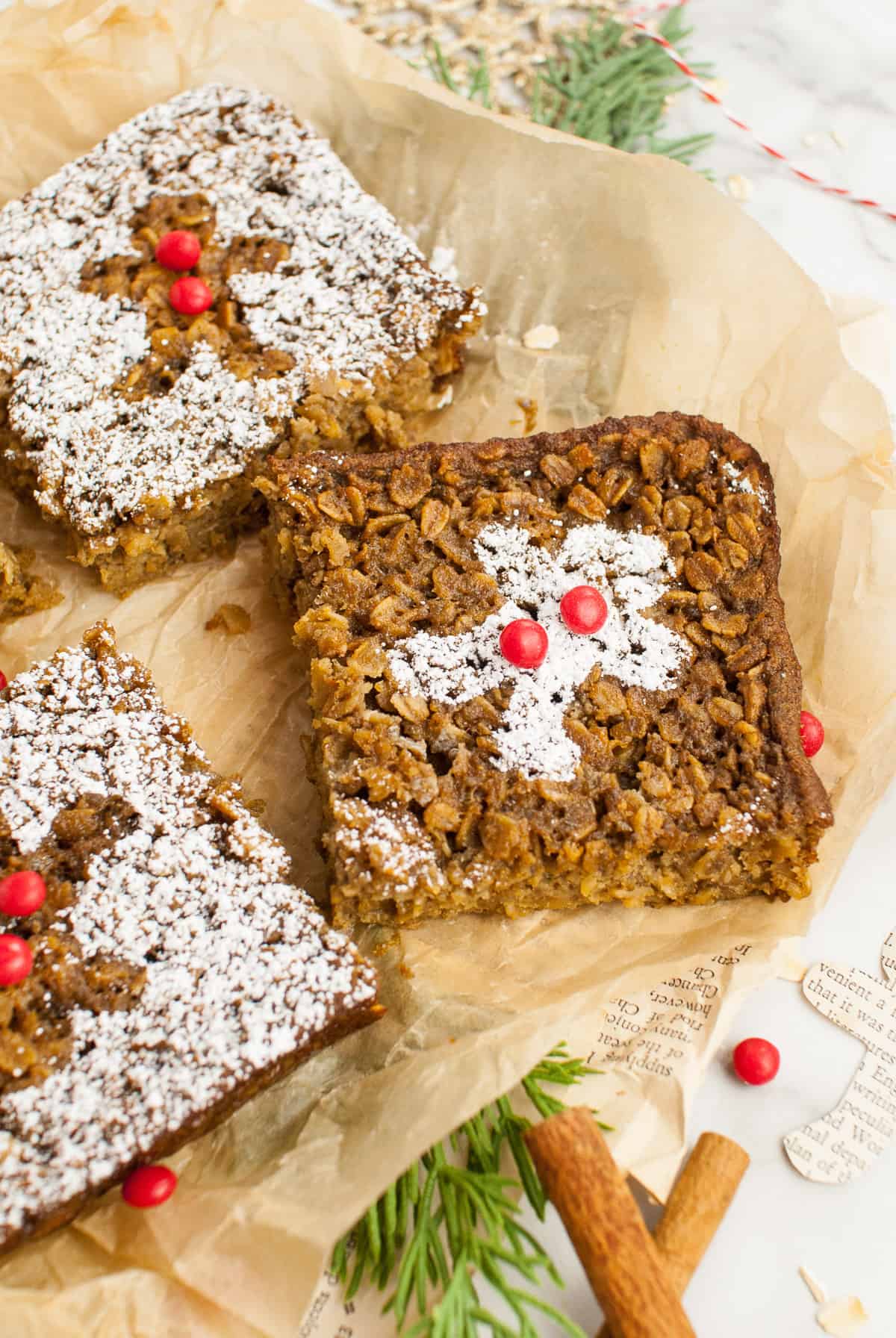 Squares of gingerbread baked oatmeal with powdered sugar dusted on top in gingerbread man cookie shapes.