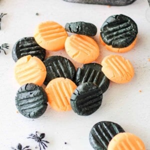 Orange and black cream cheese mints in a pile.