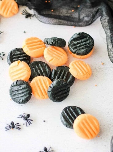 a pile of homemade black and orange Halloween candy mints.