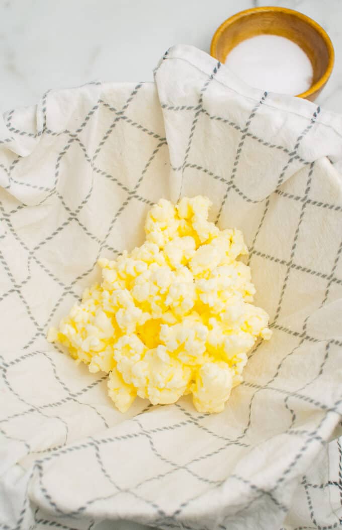 Straining fresh butter on a cheesecloth.