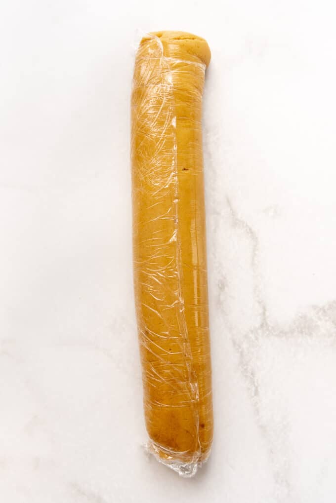 Peanut butter cookie dough rolled into a log and wrapped in plastic wrap.