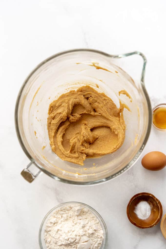 Creaming butter, sugar, and peanut butter in a mixing bowl.