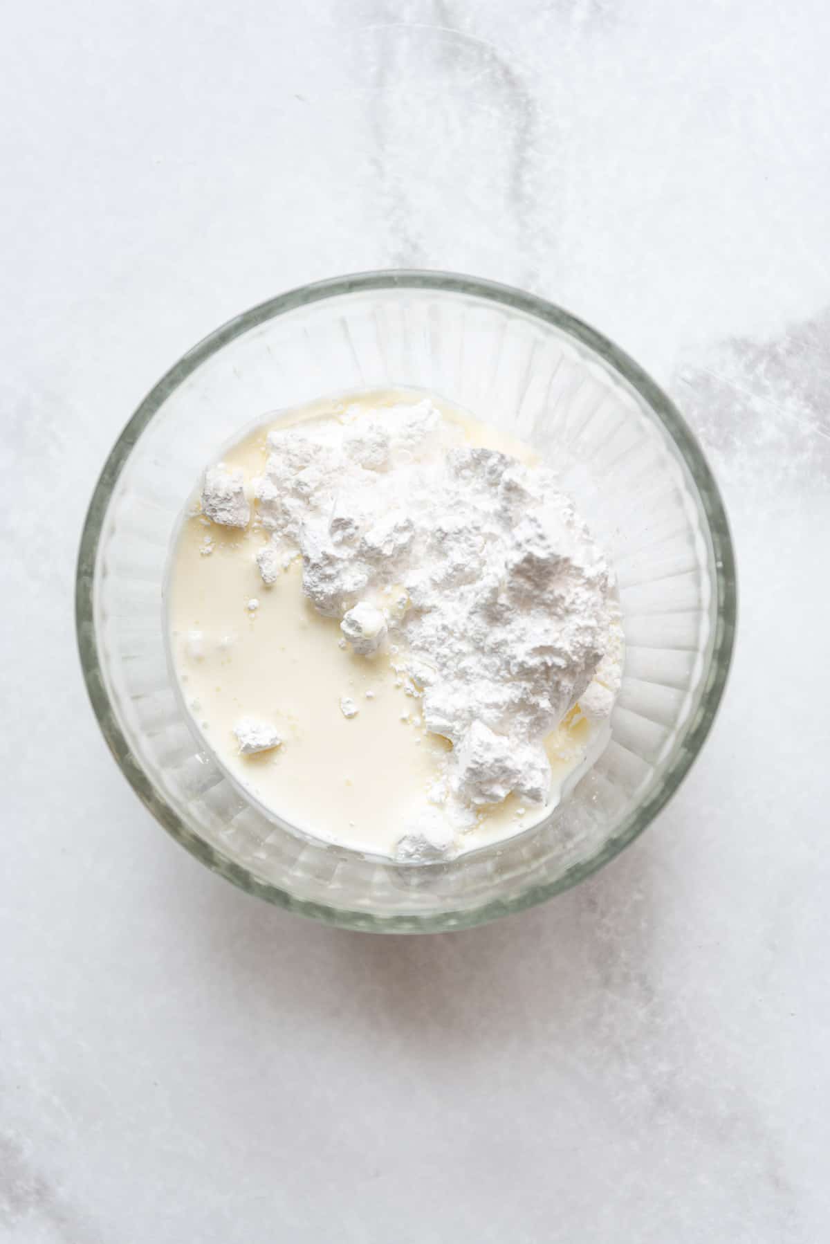 Vanilla glaze ingredients in a glass bowl.