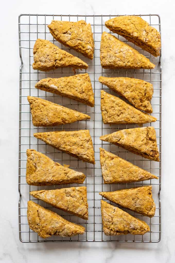 Baked pumpkin scones cooling on a wire rack.