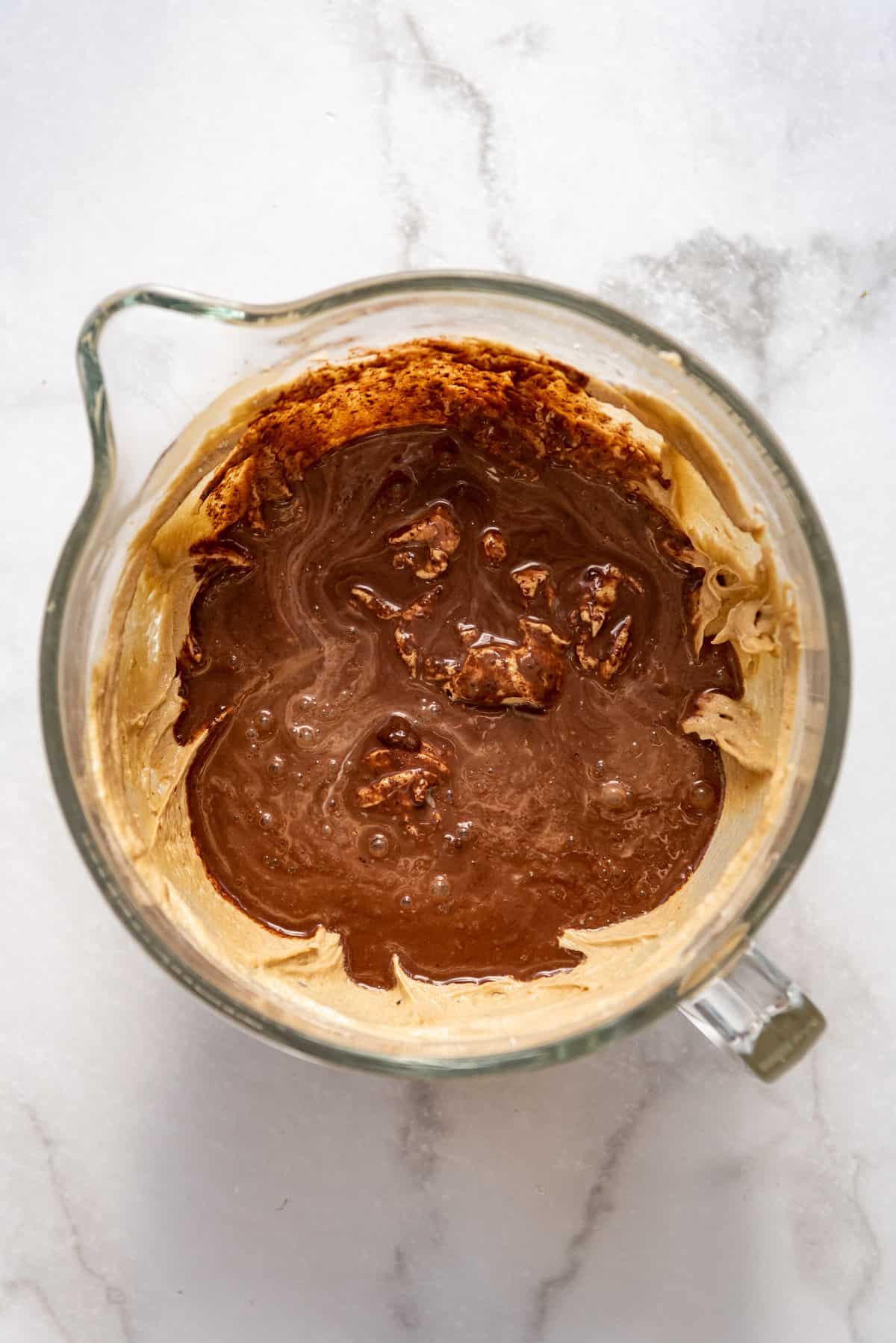 Adding melted chocolate to cake batter.