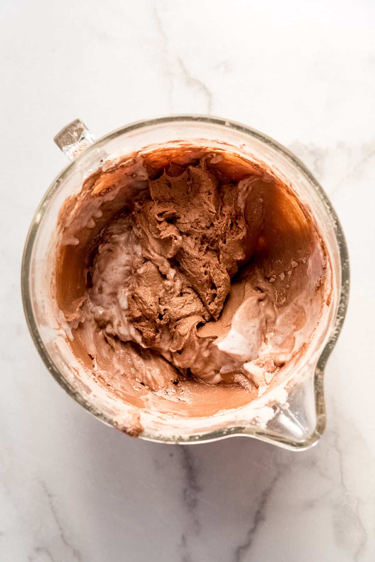 Adding buttermilk to chocolate cake batter.