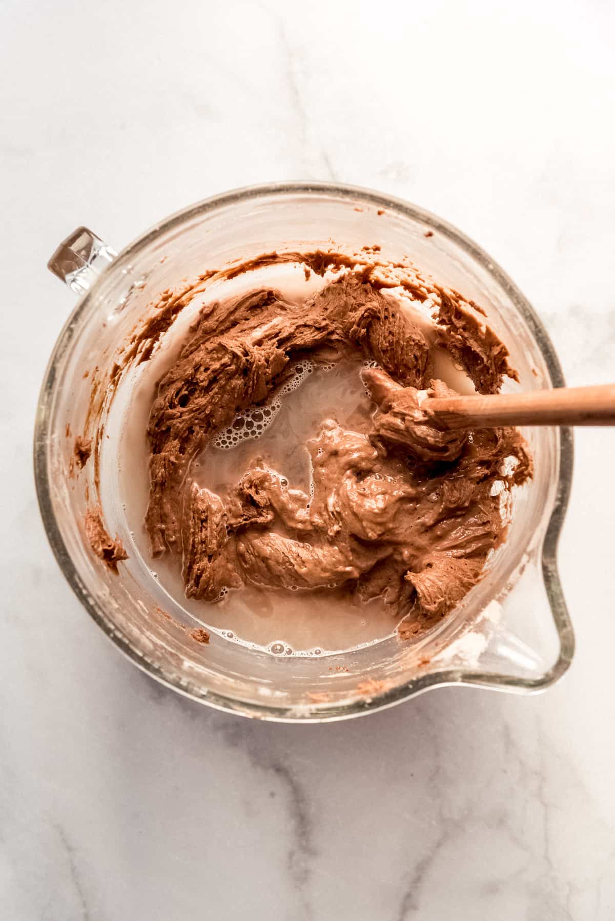 Adding boiling water to chocolate cake batter.