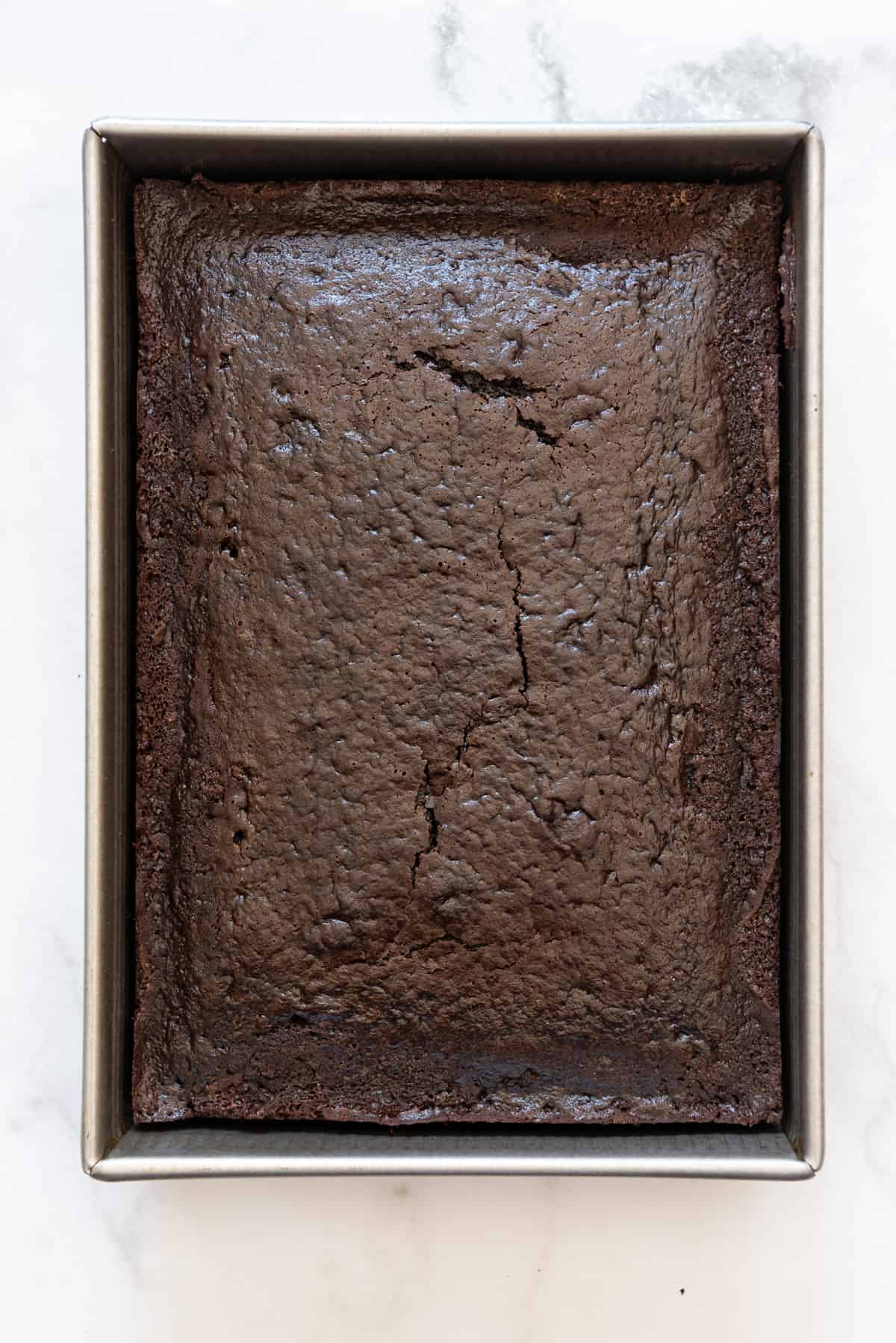 Chocolate cake in a rectangular cake pan.