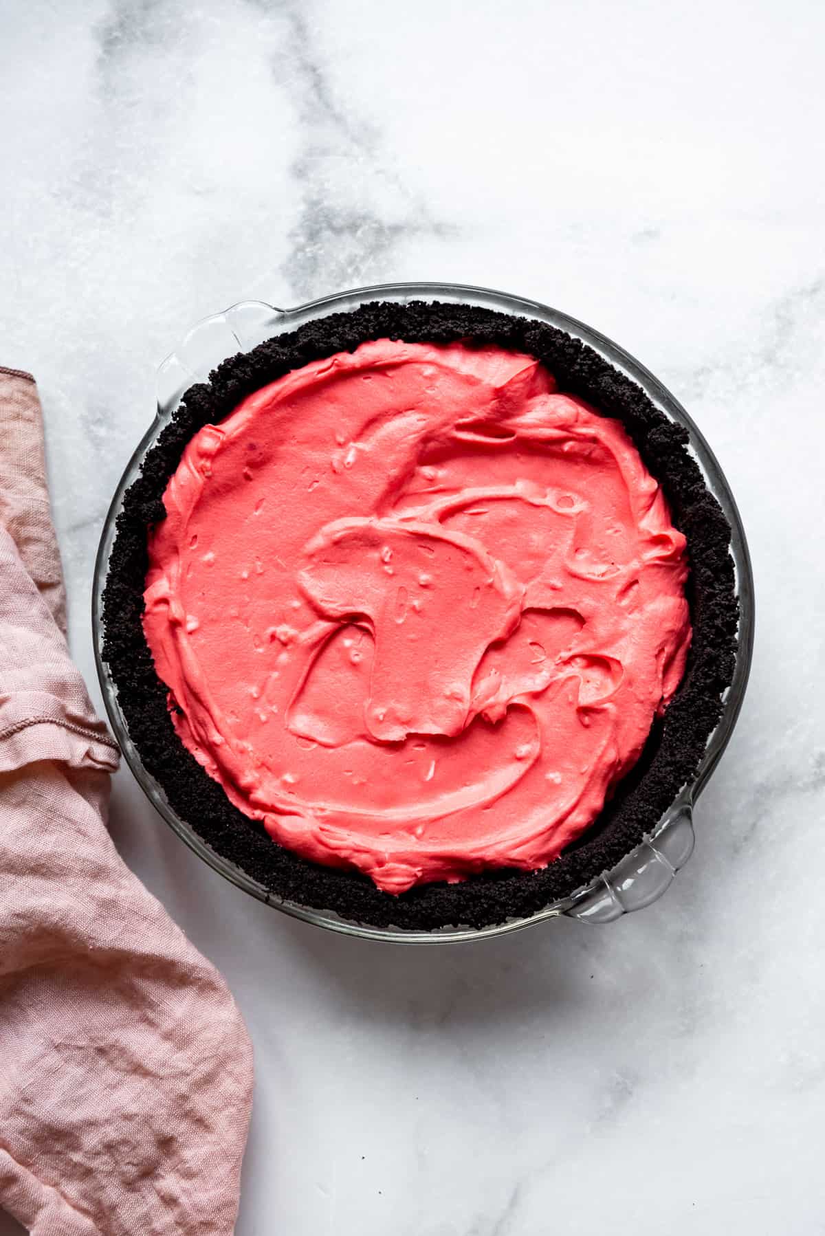 An Oreo pie crust filled with pink peppermint cheesecake filling.