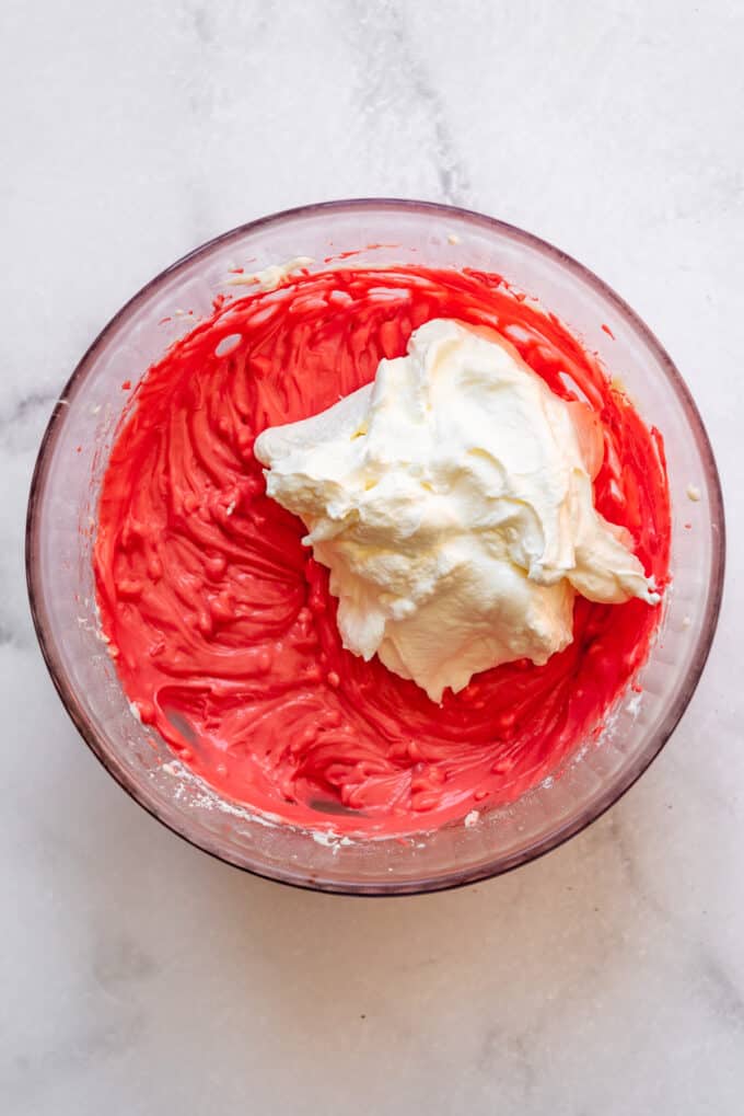 Folding whipped cream into peppermint cream cheese pie filling.