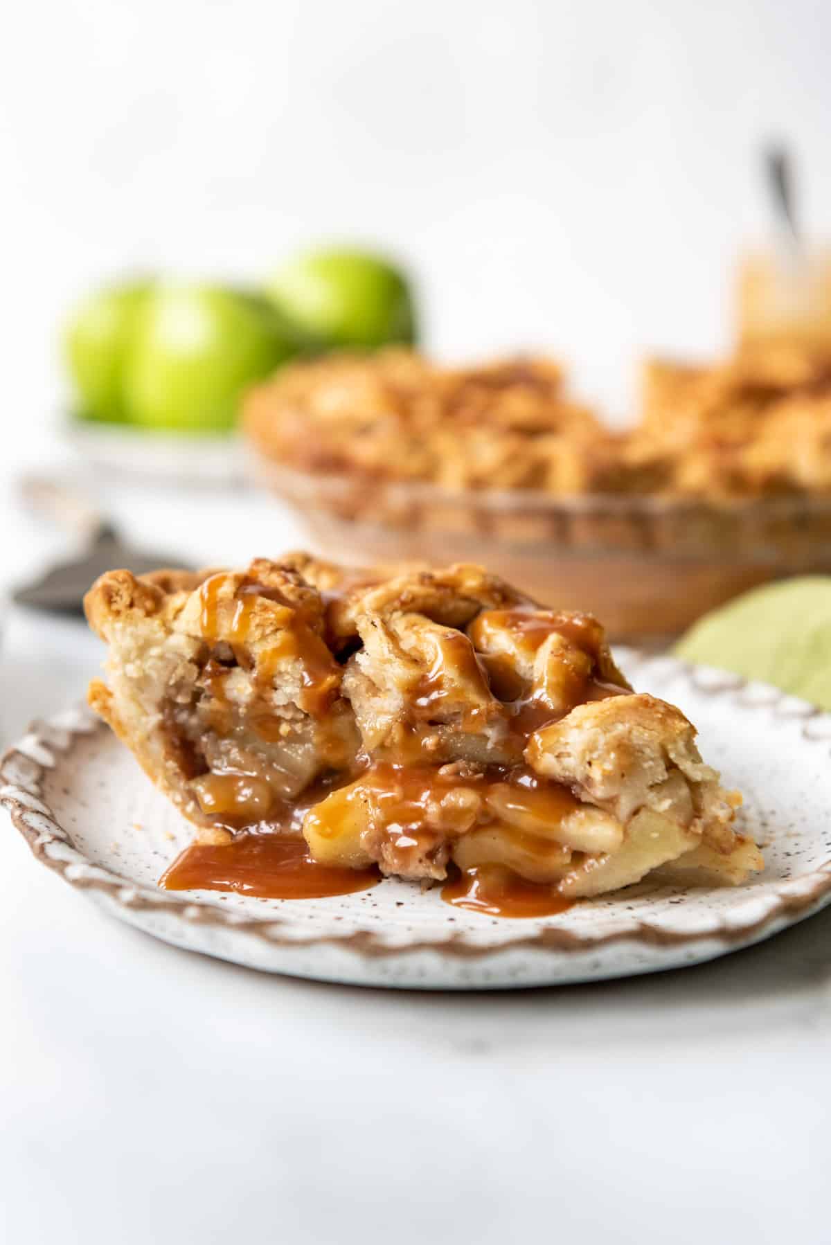 A slice of apple pie made with granny smith apples.