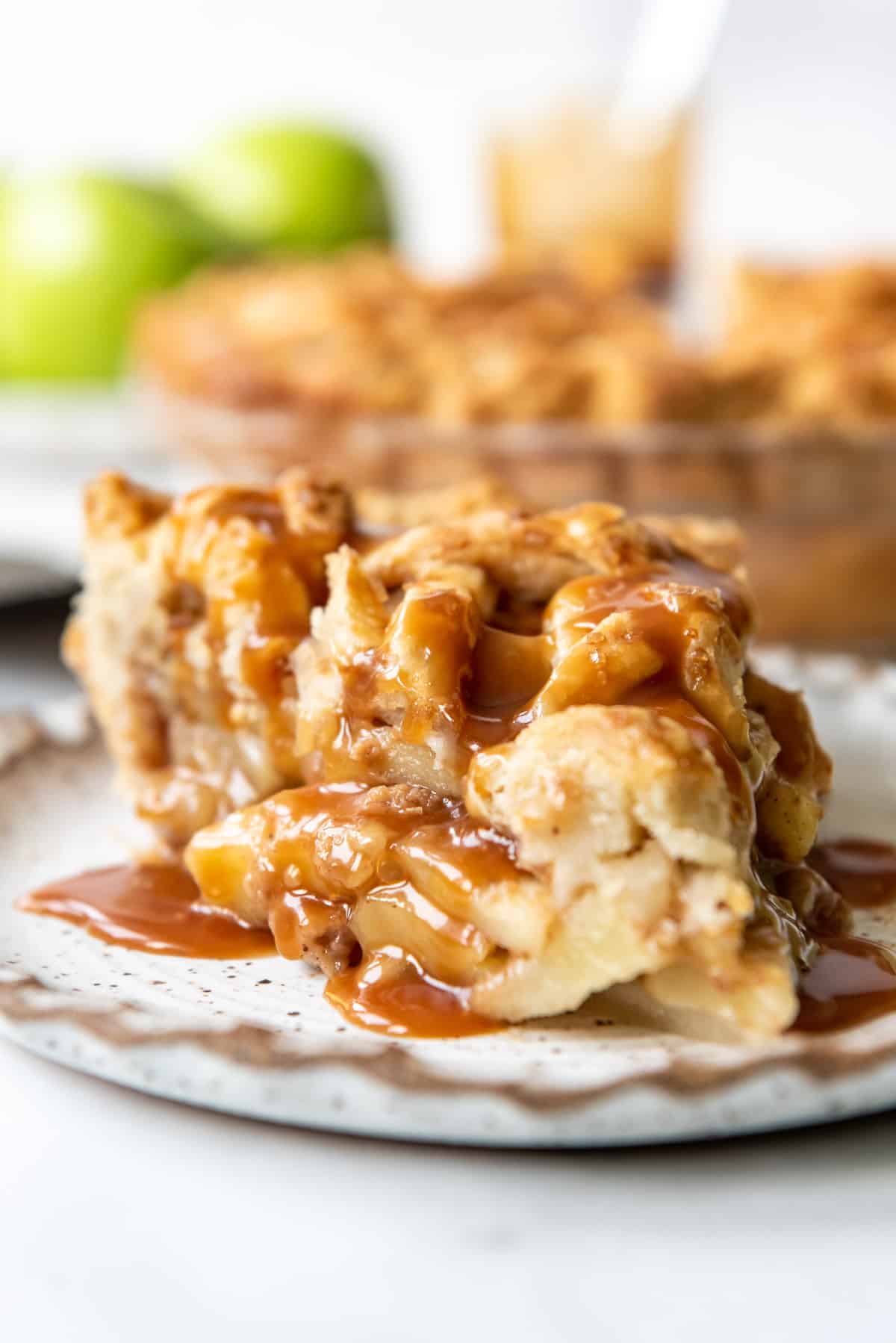 A slice of caramel apple pie on a plate.