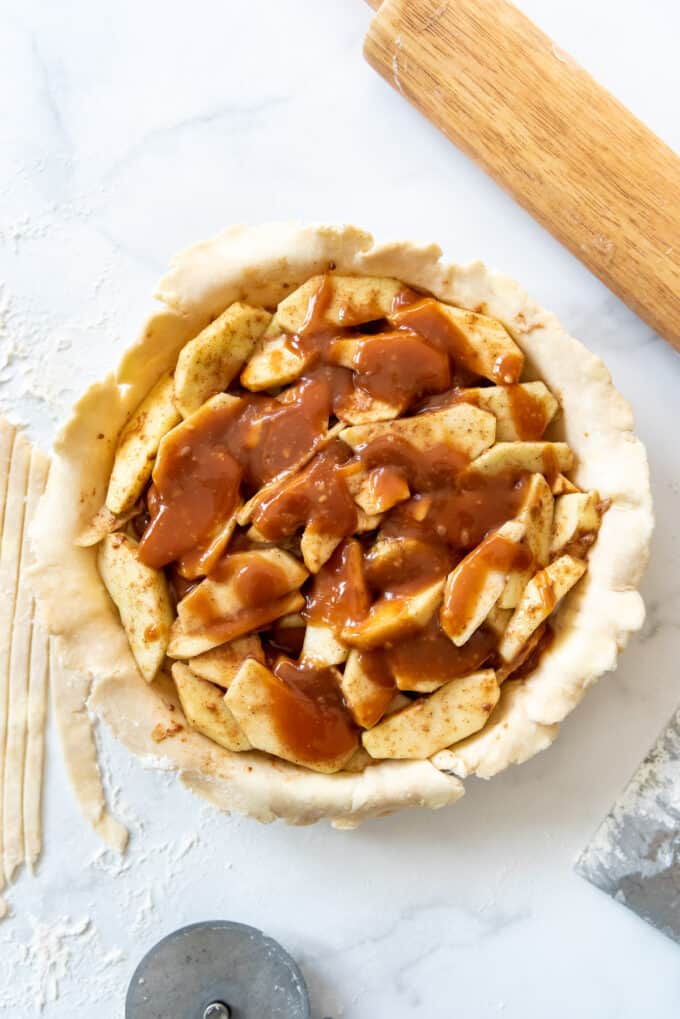 Adding salted caramel to apple pie filling.