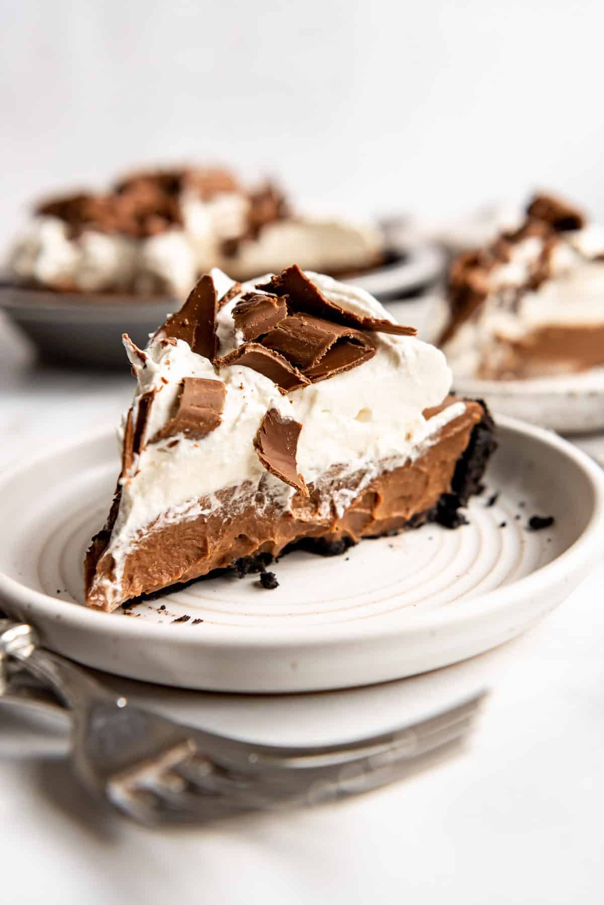A slice of chocolate pudding pie on a white plate.