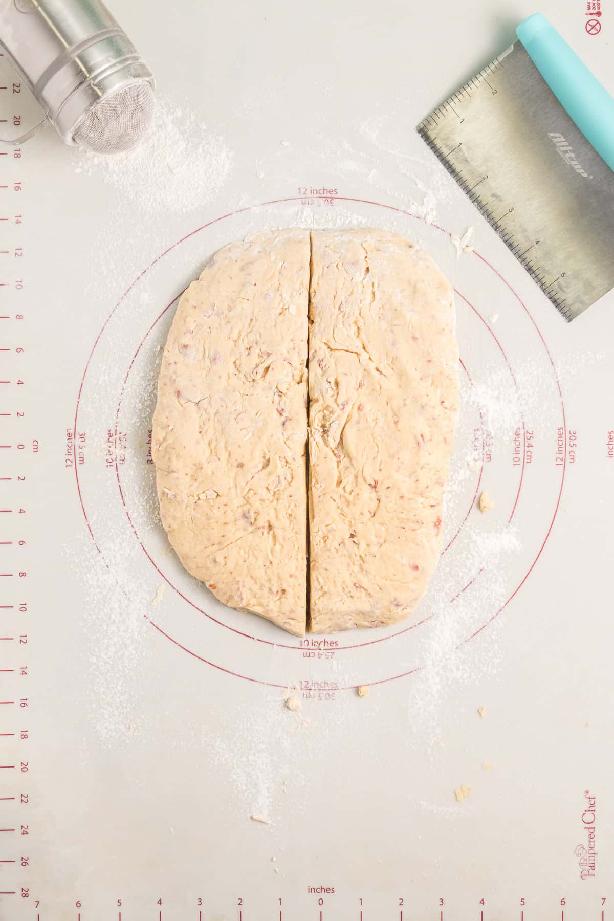 Dividing biscotti dough into two large loaves.