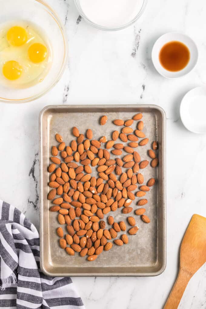 Whole almonds on a baking sheet to be toasted in the oven.