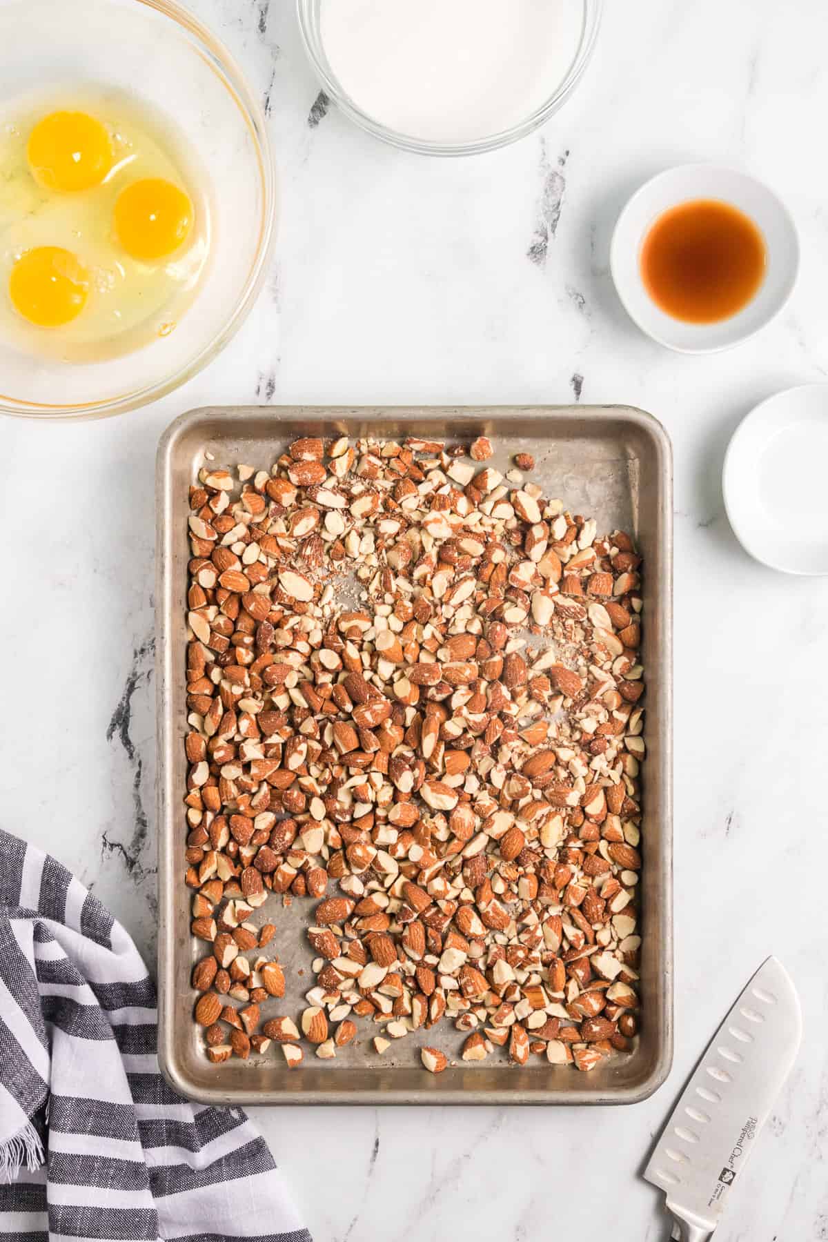 Chopped toasted almonds o n a baking sheet.