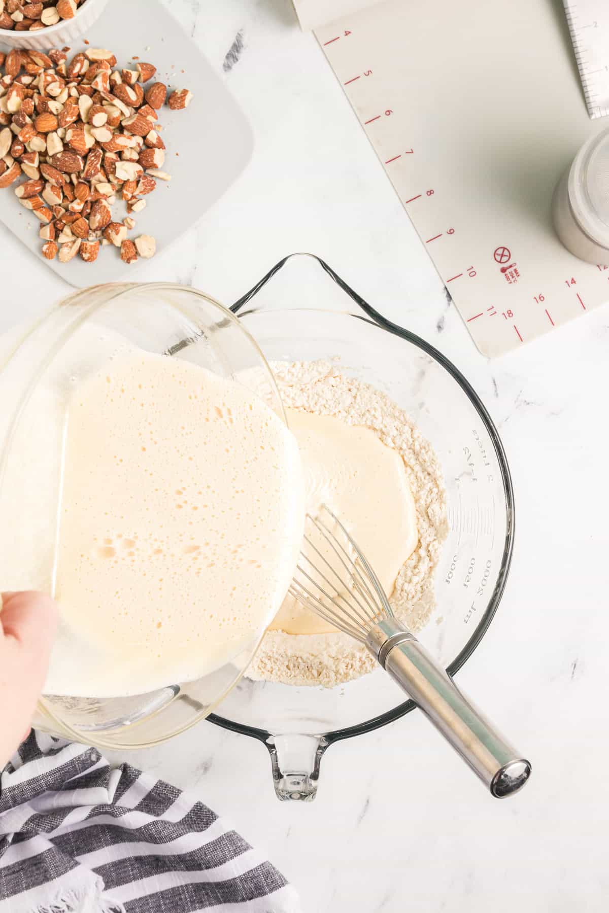 Adding thick egg and sugar mixture to dry ingredients.