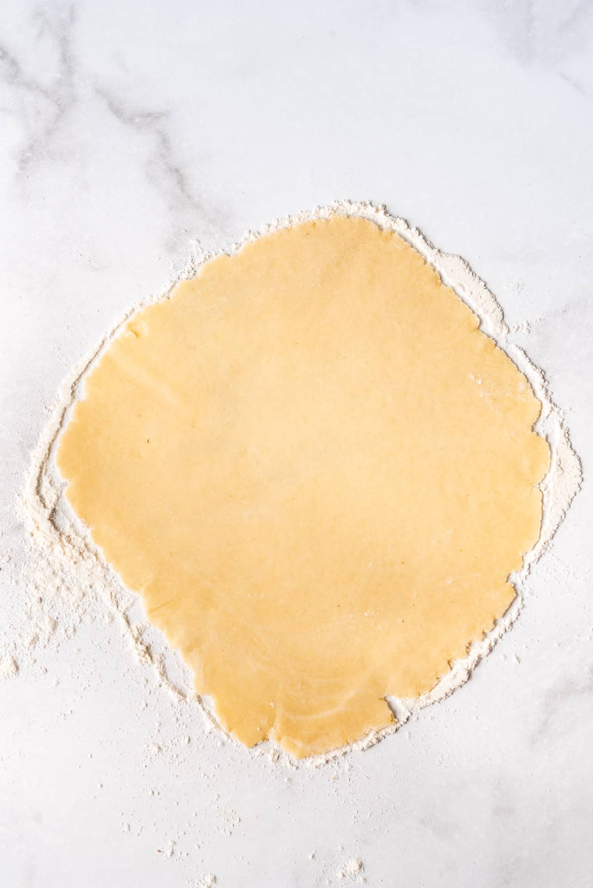 Rolled pastry dough on a floured surface.