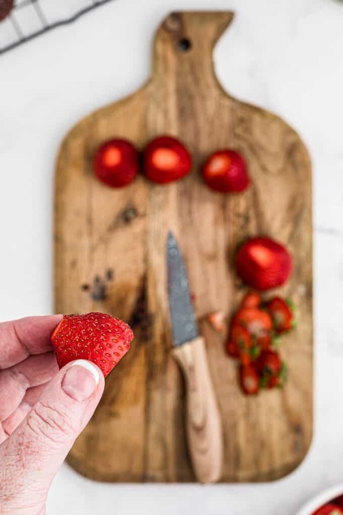 Cutting off the tips of strawberries.