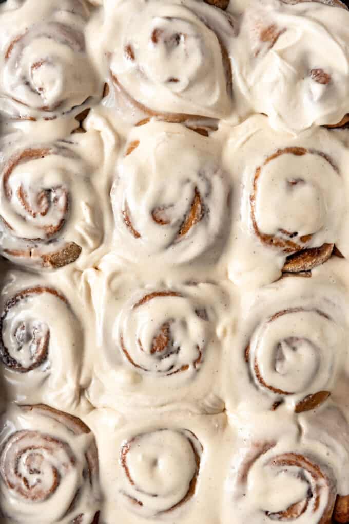 Swirled gingerbread cinnamon rolls spread with spiced cream cheese frosting.