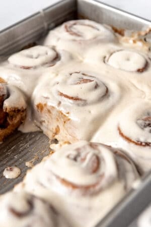 Gingerbread cinnamon rolls in a baking dish.