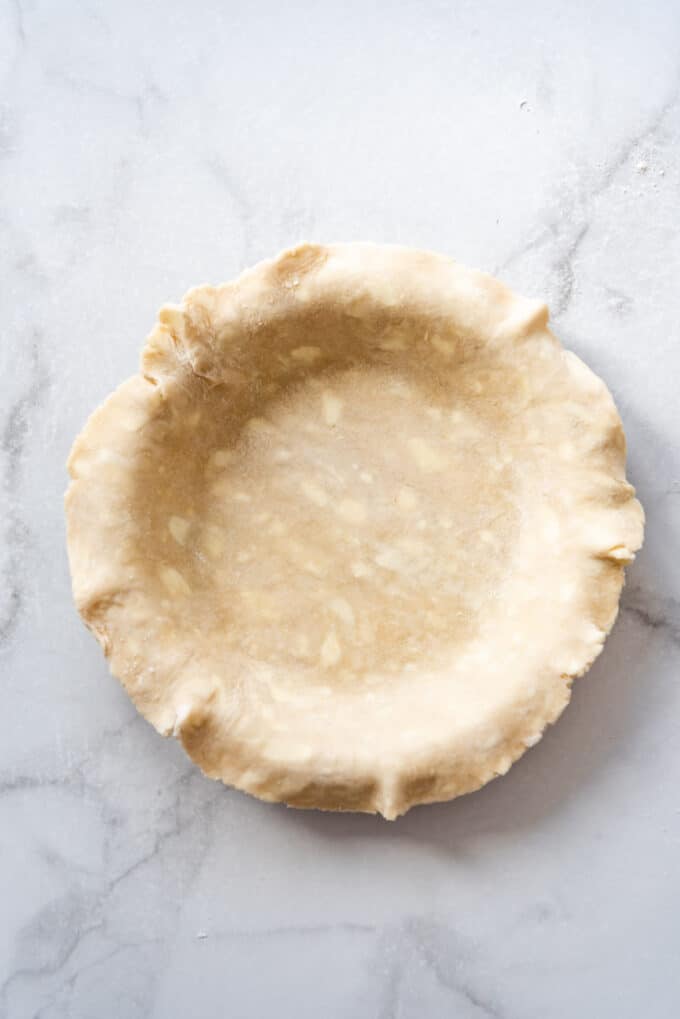 An unbaked pie crust in a pie plate.