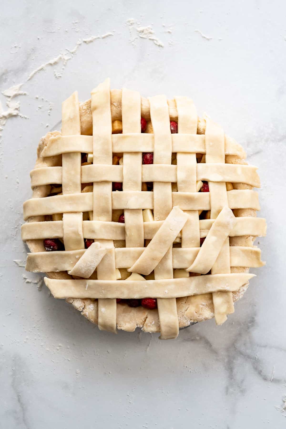 Placing the last row of pie crust dough.