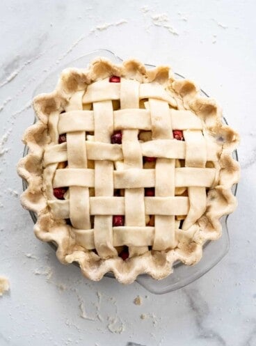 An overhead image of a lattice pie crust before baking.
