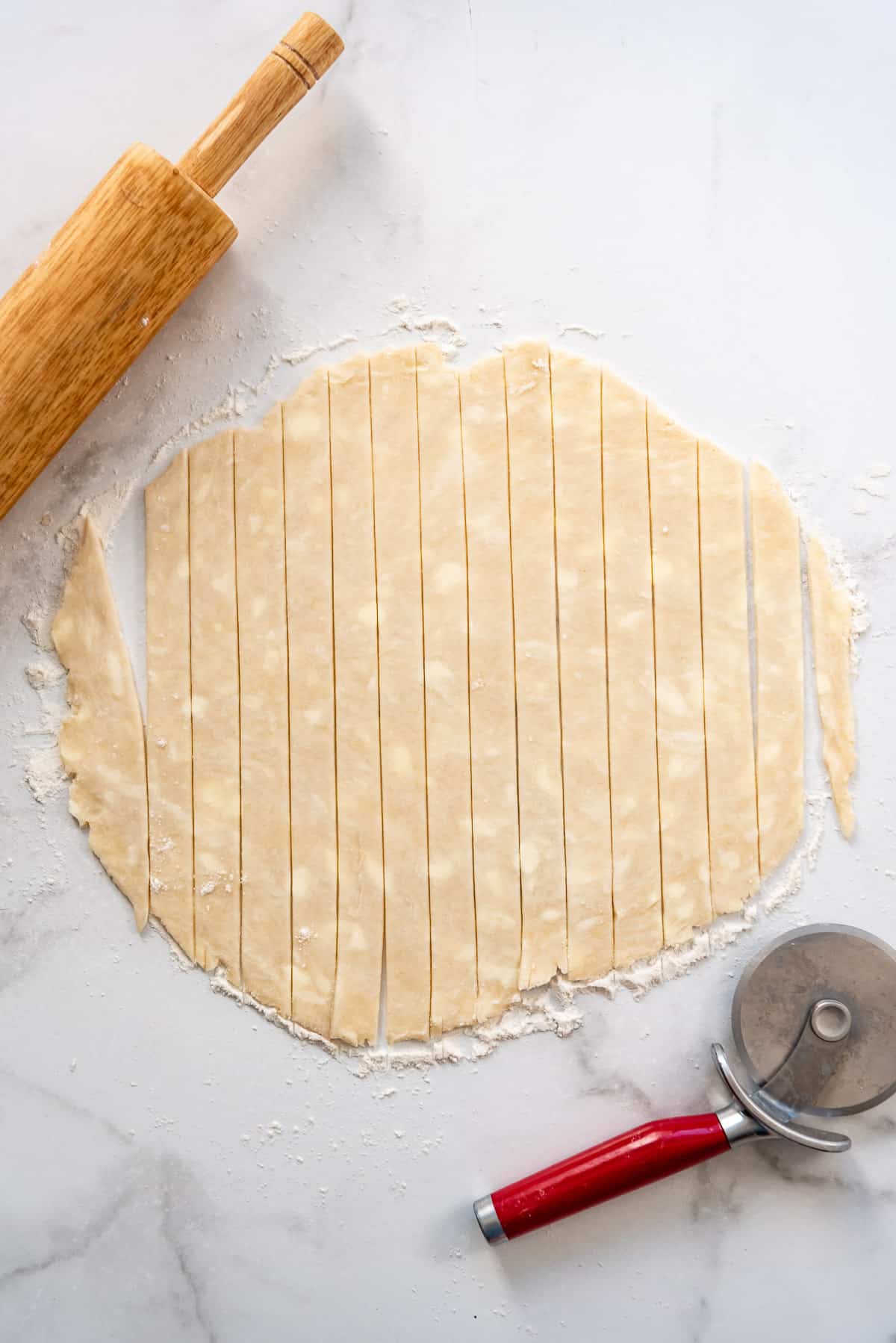 Pie dough cut into strips for a lattice crust.
