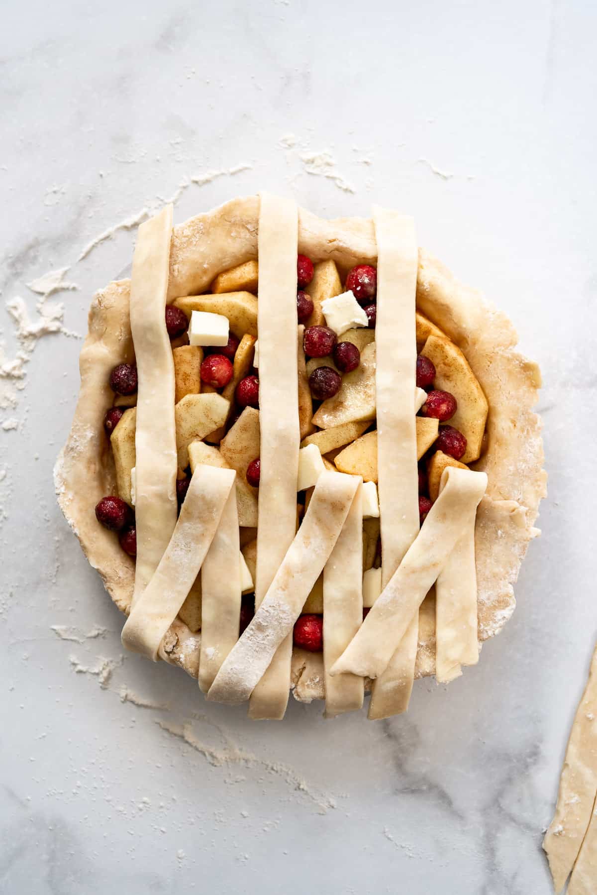 Strips of pie crust folded back to create a lattice pie crust.