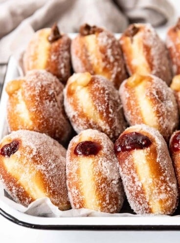 Three types of packzi jelly donuts arranged on end in rows.