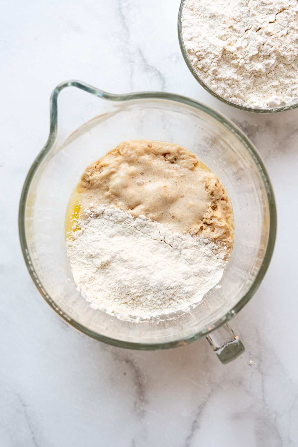 Combining some of the flour with the eggs, butter, and yeast.