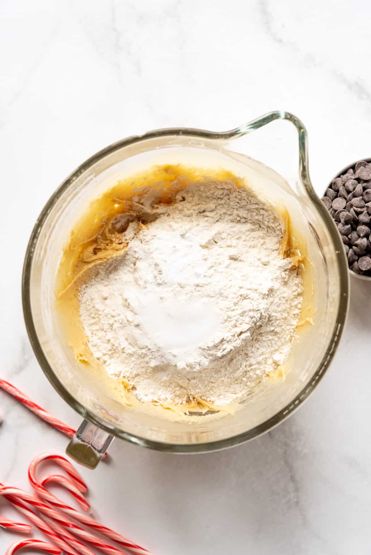 Adding dry ingredients to cookie dough.