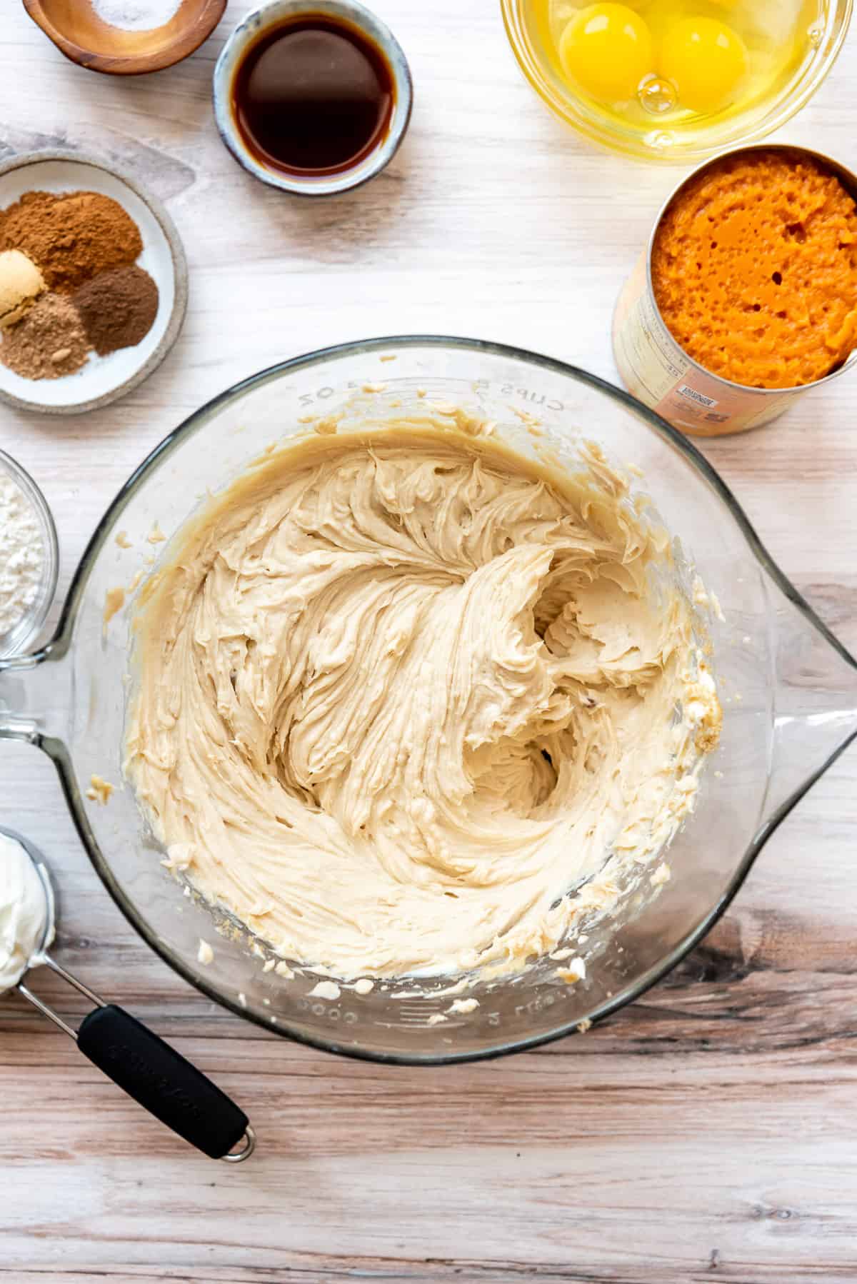 Beating cream cheese and brown sugar in a bowl.