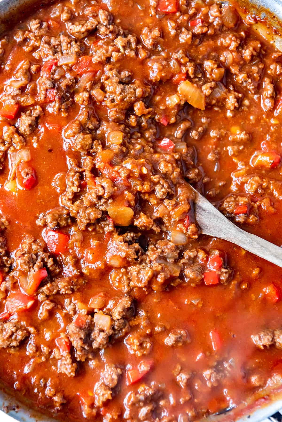 A close up image of browned ground beef and vegetables in homemade sloppy joe sauce.