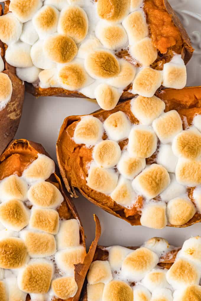 A close image of toasted marshmallows on creamy twice baked sweet potatoes.
