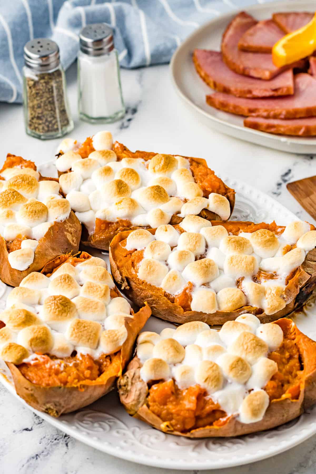 A serving plate loaded with twice baked mashed sweet potatoes topped with toasted marshmallows.