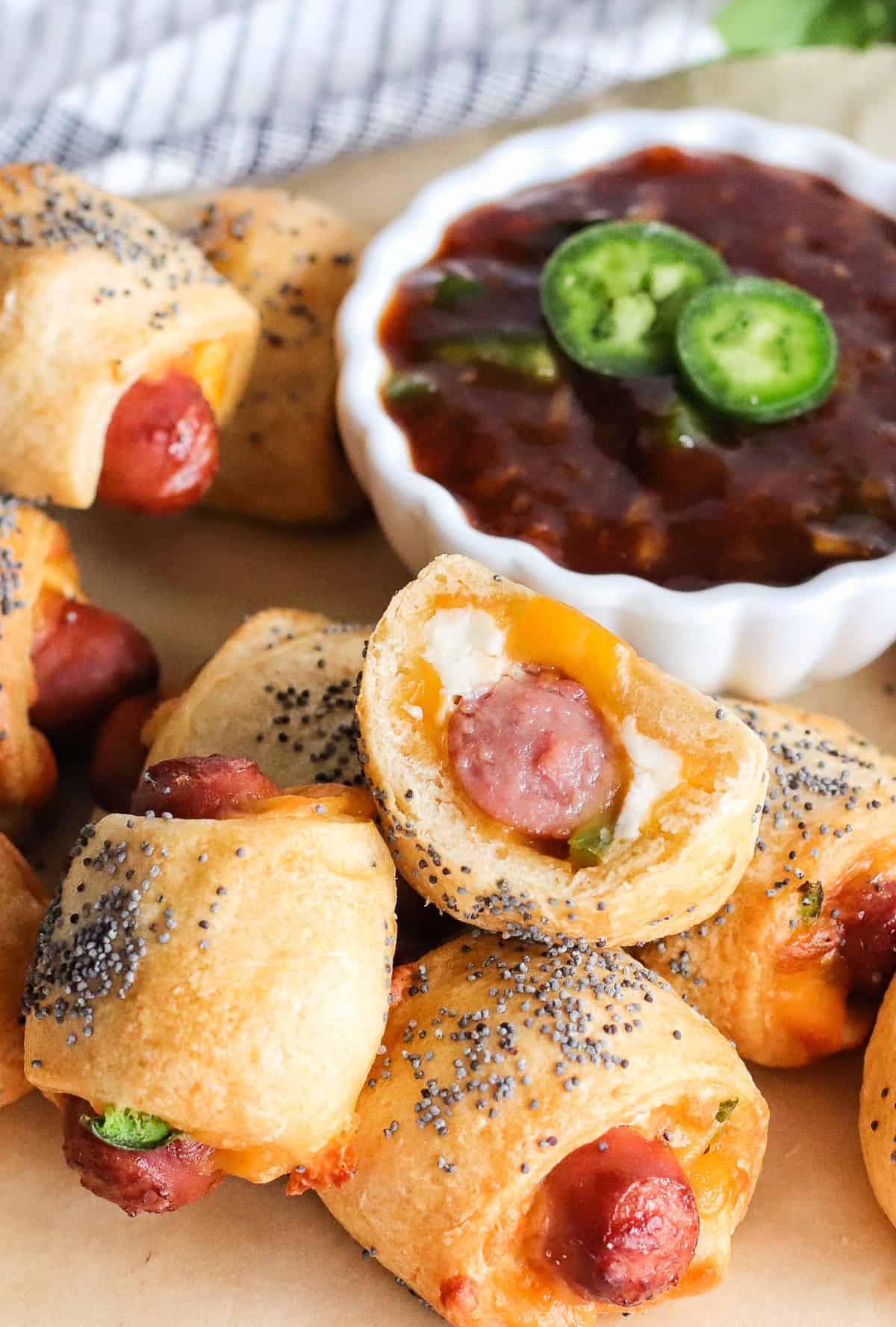 Pigs in a blanket with cheddar cheese, cream cheese, and jalapeno.