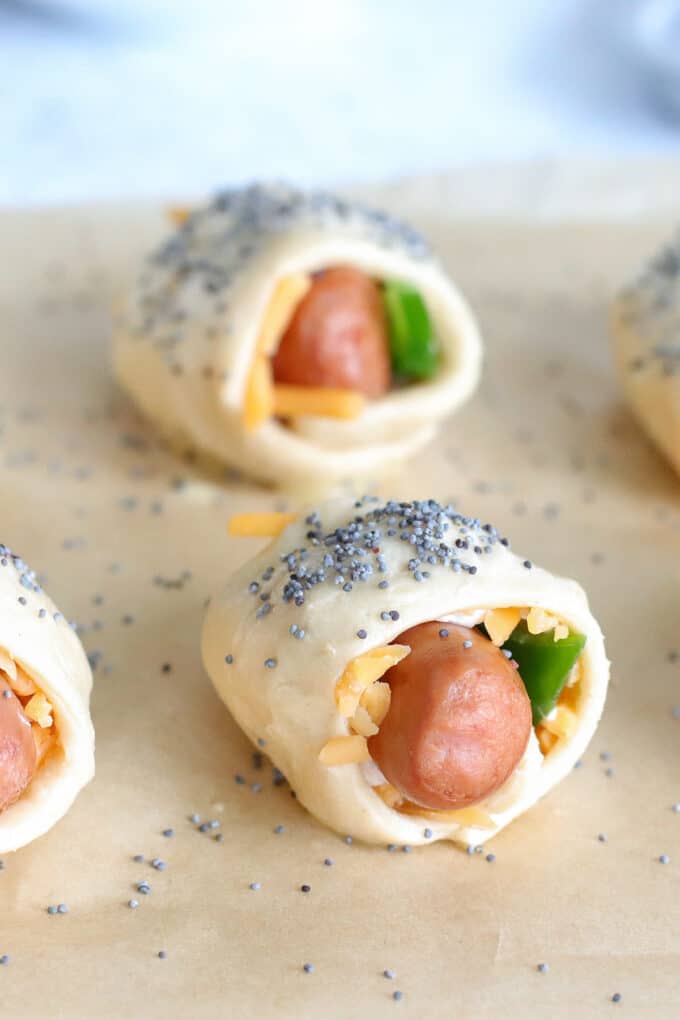 Lil smokies wrapped in crescent roll dough with cheddar cheese and jalapeno peppers.