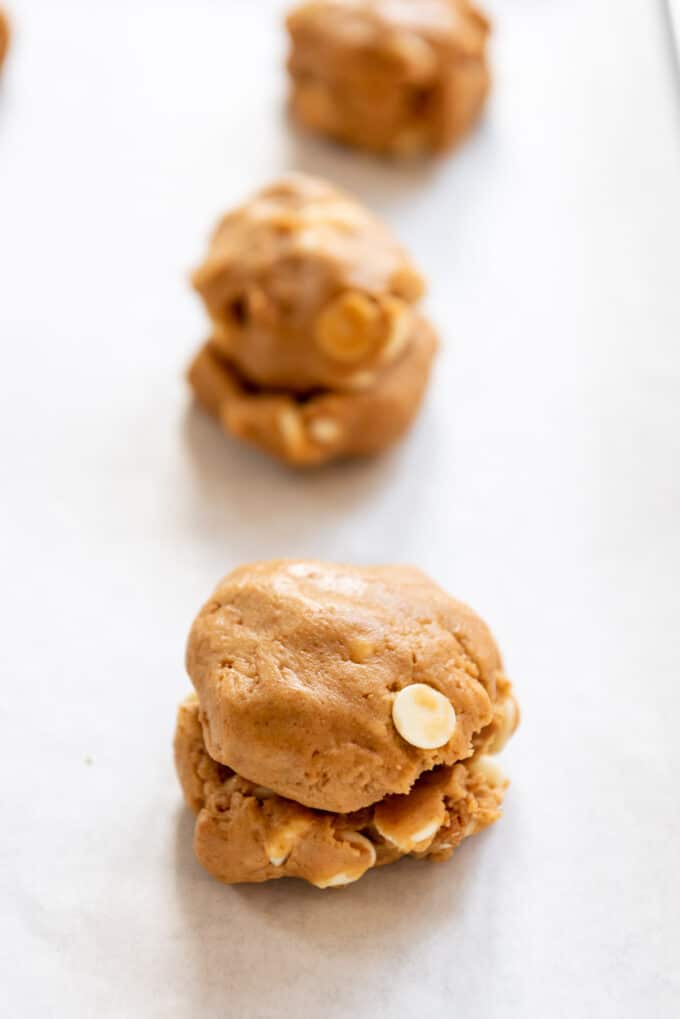 Topping cookie dough filled with cookie butter with another chunk of cookie dough.