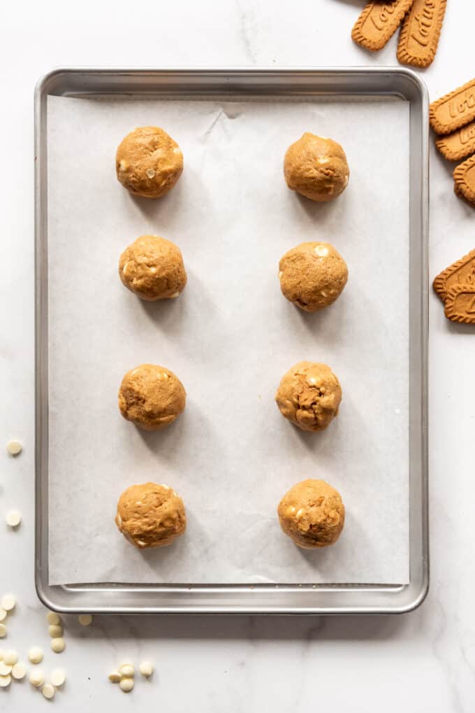 Either large balls of biscoff cookie butter cookie dough on a baking sheet lined with parchment paper.